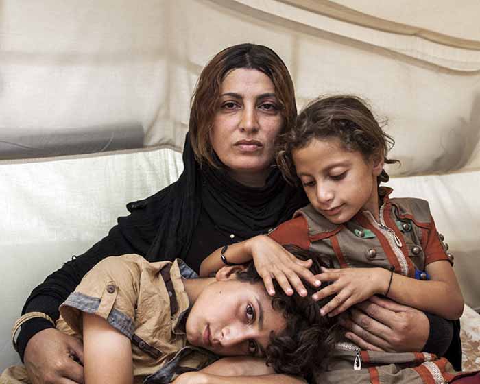 © Ivor Prickett. Amira and her Children, 2014. © UNHCR/Panos Pictures  